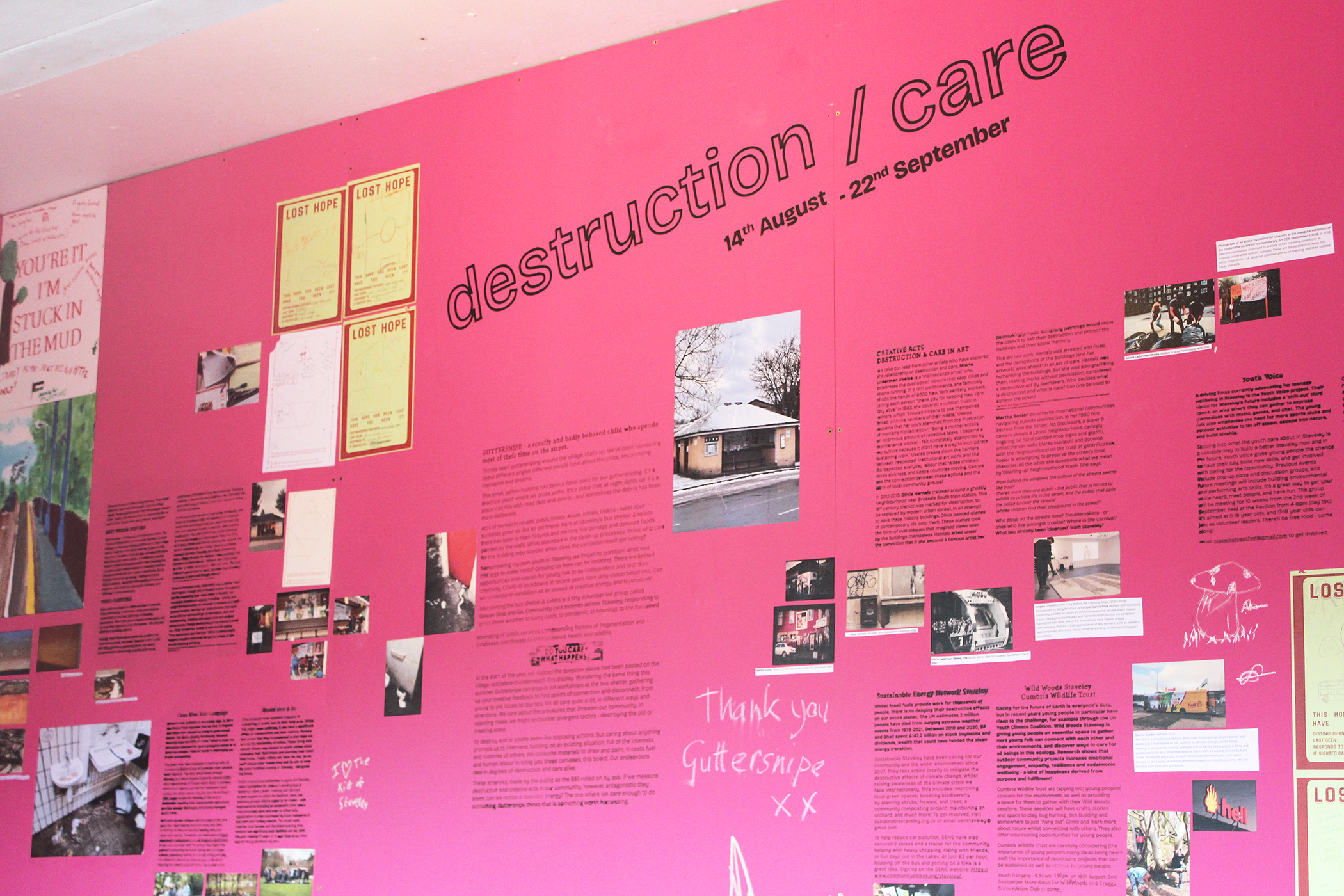 pink wall with images and black text under the title 'destruction/care'